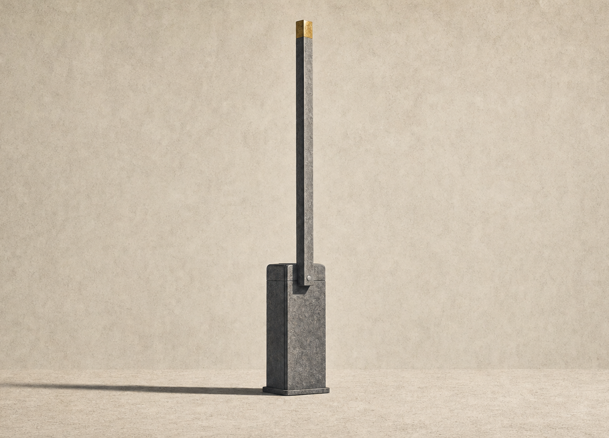 A barrier arm of the kind that blocks a vehicle entrance, raised and standing alone on an empty floor, with no fence or gate around it.